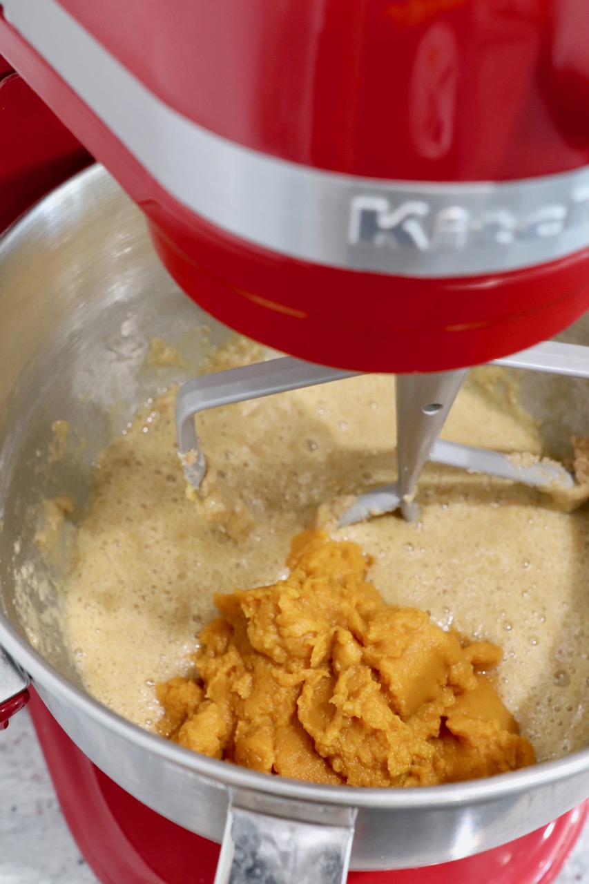 cupcake batter in stand mixer with pumpkin puree