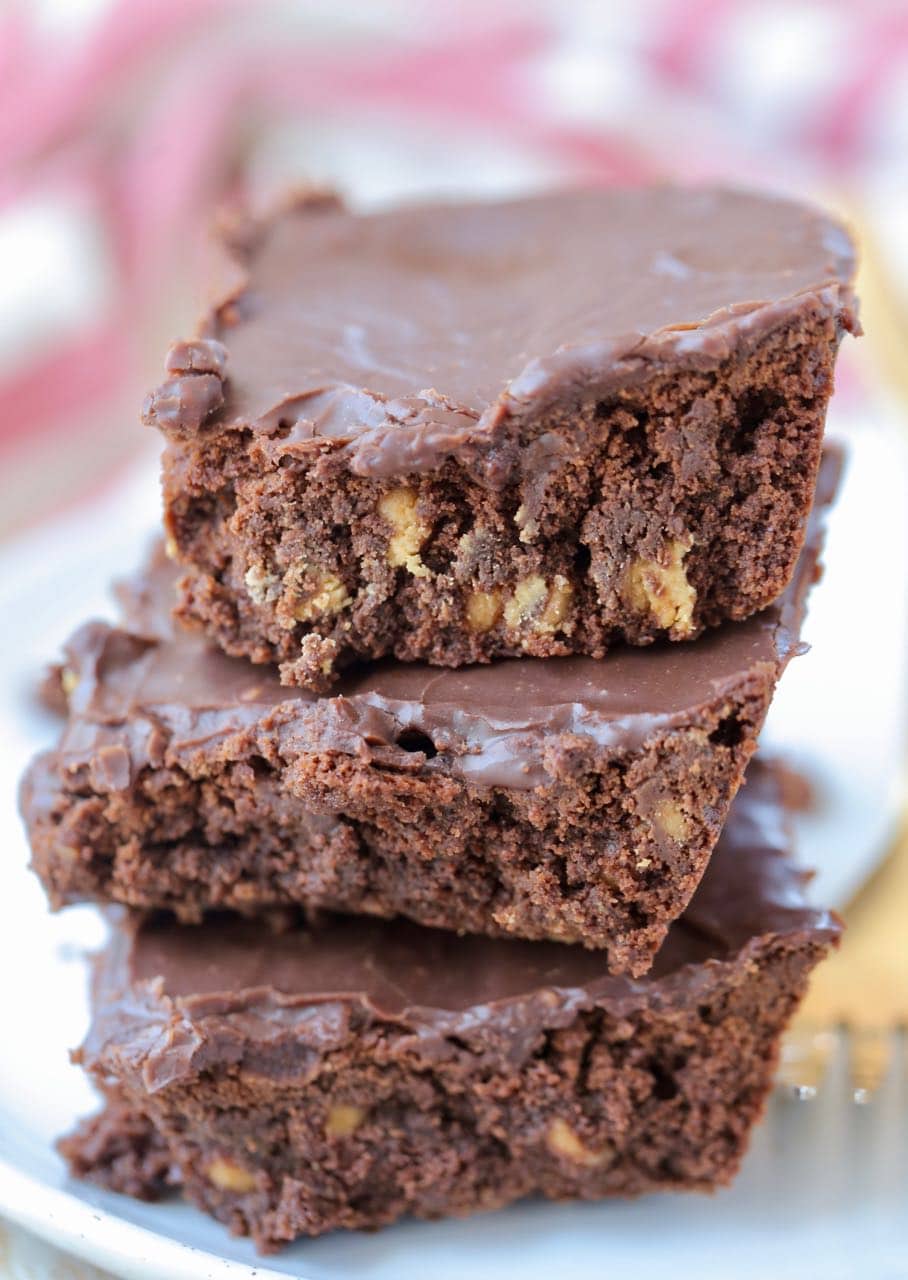 Stack of three double chocolate brownies on plate
