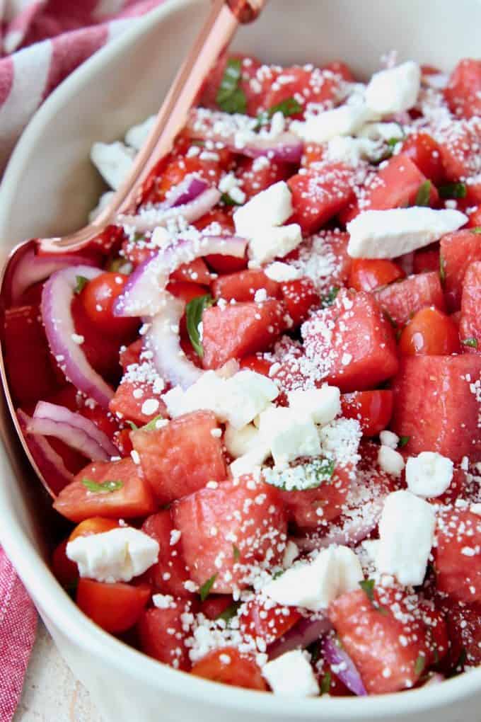 Diced watermelon salad in bowl with spoon