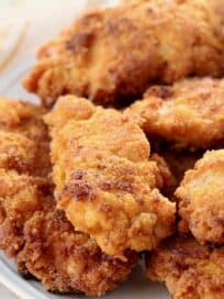 fried chicken tenders piled up on plate