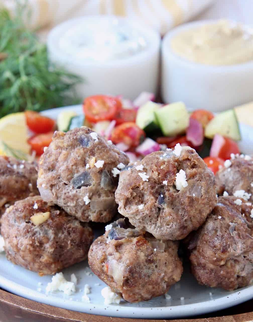 Greek meatballs on plate topped with crumbled feta cheese