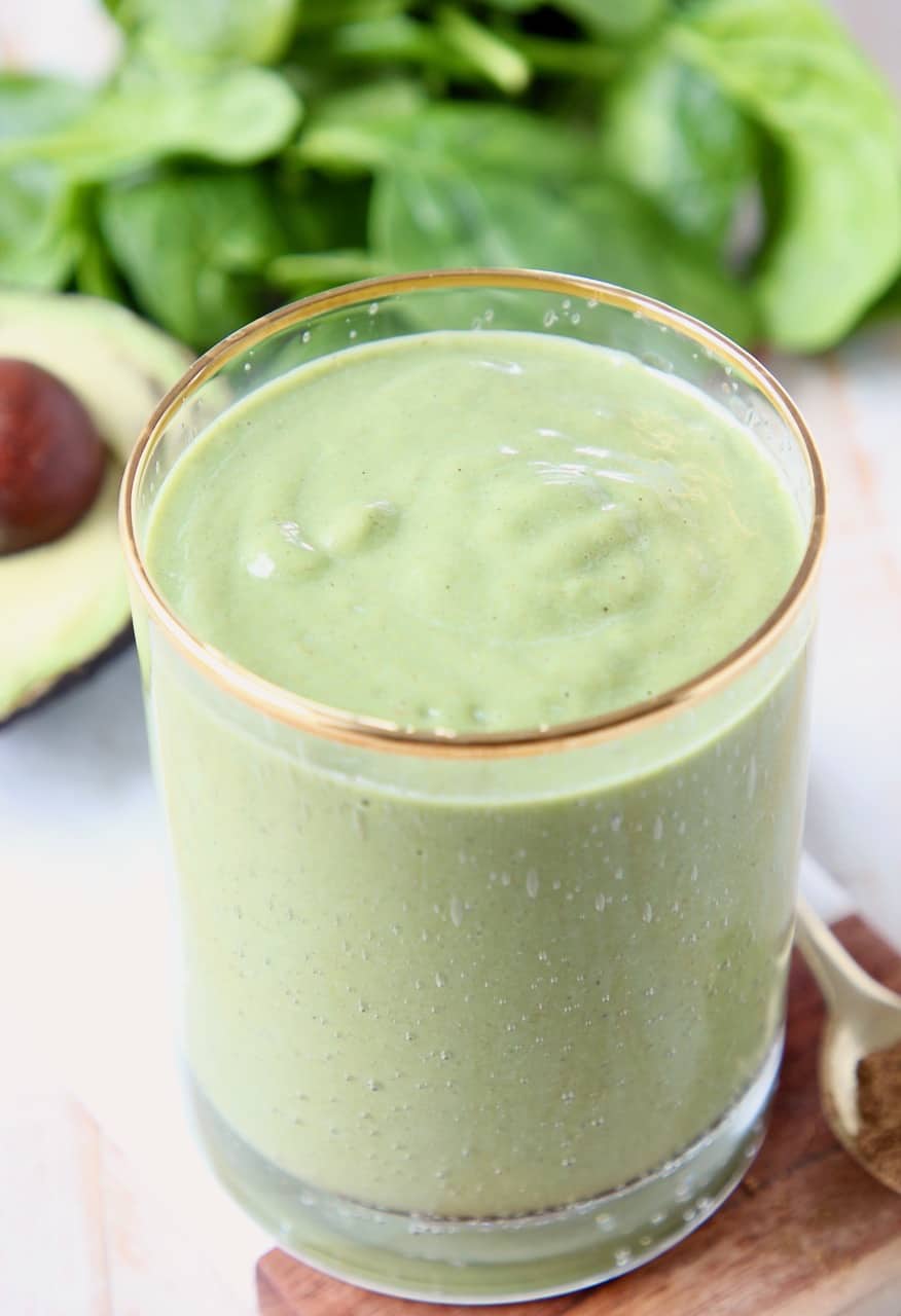 Green smoothie in clear glass with gold rim