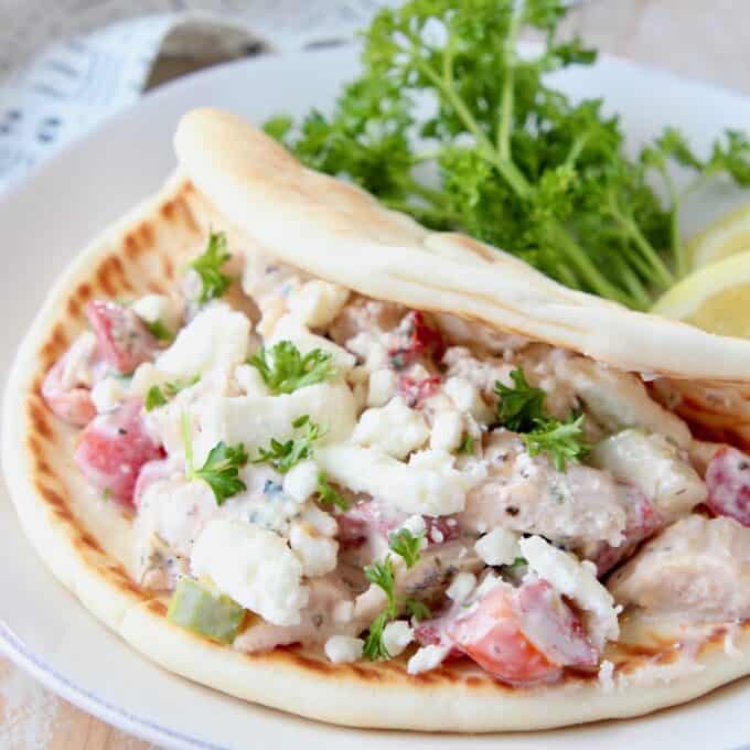 chicken salad in pita bread on plate with parsley