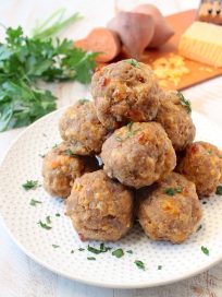 This delicious recipe for gluten free sausage balls combines creamy mashed sweet potatoes with homemade gluten free bisquick mix, cheddar cheese & sausage!