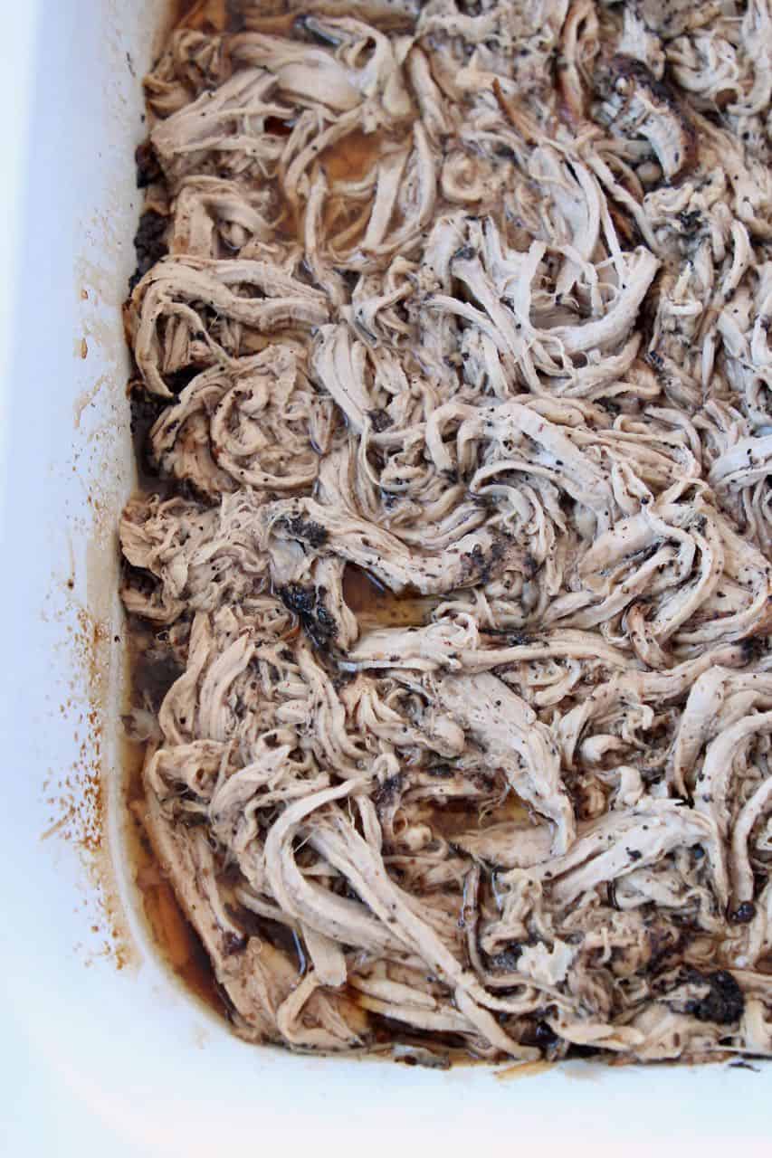 Crock pot filled with coffee crushed pulled pork tenderloin