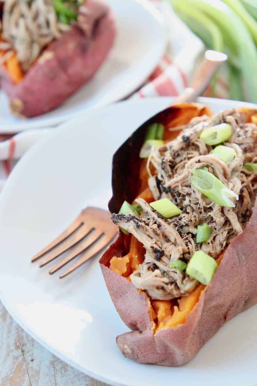 Pulled pork tenderloin in sweet potato topped with diced green onions