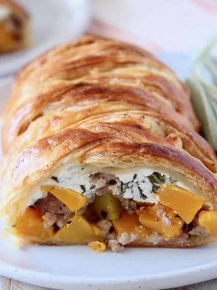 Puff pastry strudel cut open, filled with cubes of butternut squash and ricotta cheese