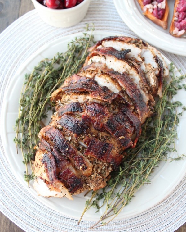 This bacon wrapped turkey breast is covered in a balsamic garlic herb rub then wrapped in a bacon weave for a flavorful, juicy turkey recipe!
