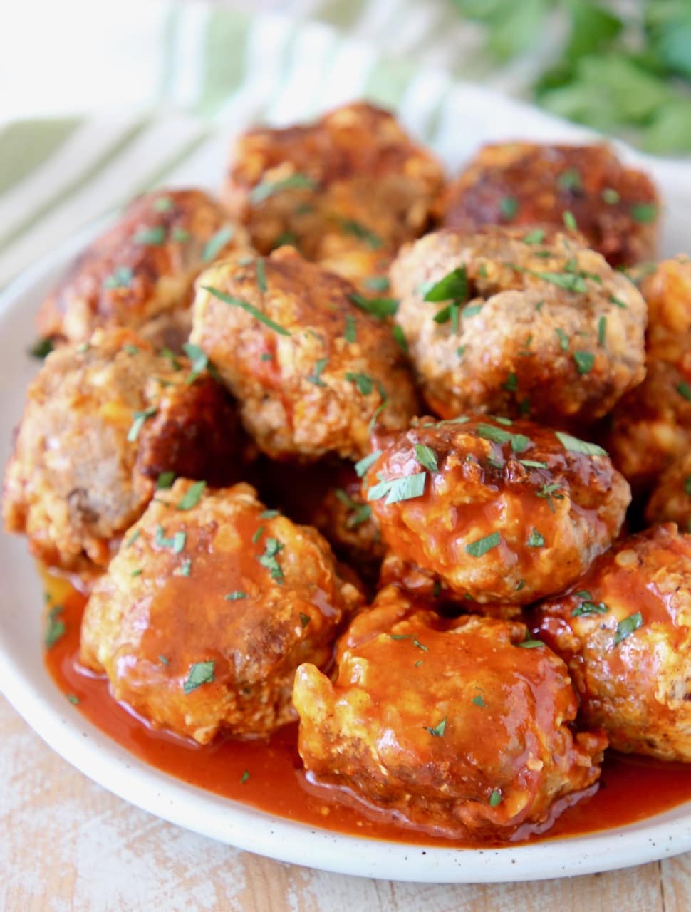 Cheesy Sausage Balls covered in Buffalo Sauce with Fresh Cilantro