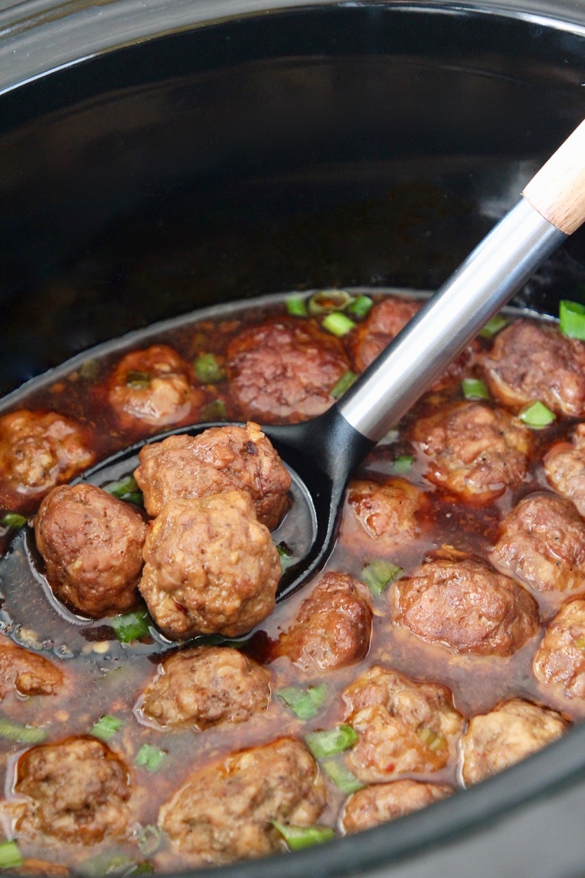 Korean bbq meatballs in spoon in crock pot