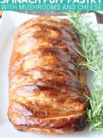 Baked braided puff pastry on plate with fresh rosemary sprigs