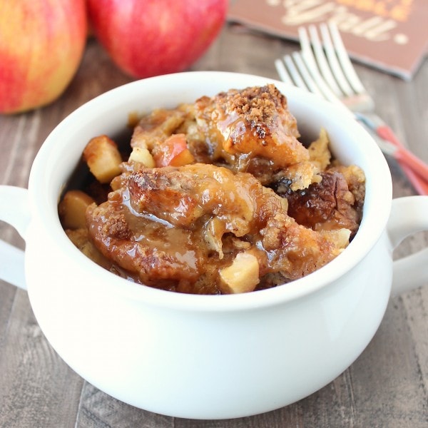 cooked caramel apple bread pudding in white serving bowl