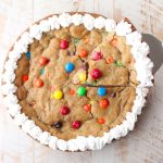 The Ultimate Candy Cookie Cake recipe is perfect for Halloween, birthdays or holidays, add your favorite candy to cookie dough & bake into a tasty cake!