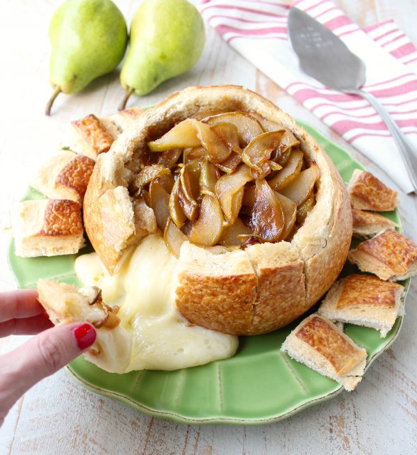 Hand pulled bread from baked brie bread bowl with caramelized pears