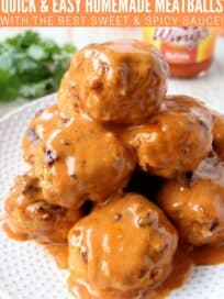 Meatballs covered in buffalo sauce stacked up on plate