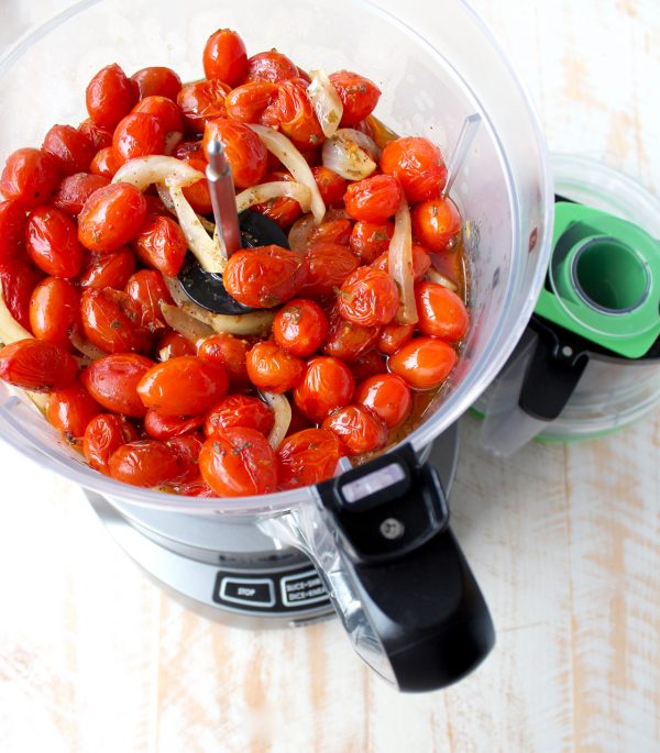 overhead image of roasted tomatoes and onions in food processor