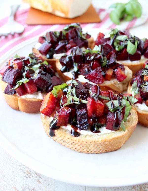 A toasted baguette is topped with goat cheese, balsamic roasted beets, fresh basil & balsamic reduction in this vegetarian Beet Bruschetta recipe that's perfect for Spring!