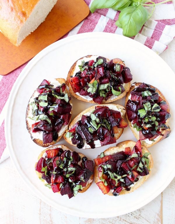 A toasted baguette is topped with goat cheese, balsamic roasted beets, fresh basil & balsamic reduction in this vegetarian Beet Bruschetta recipe that's perfect for Spring!