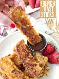 crispy french toast stick dipped into honey
