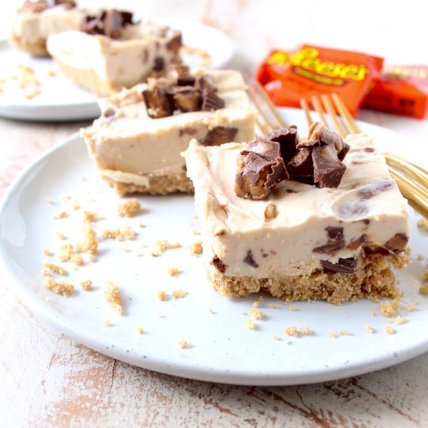 No bake cheesecake bars are a deliciously easy dessert, made with Reese's Peanut Butter Cups, they're filled with chocolate, peanut butter goodness!