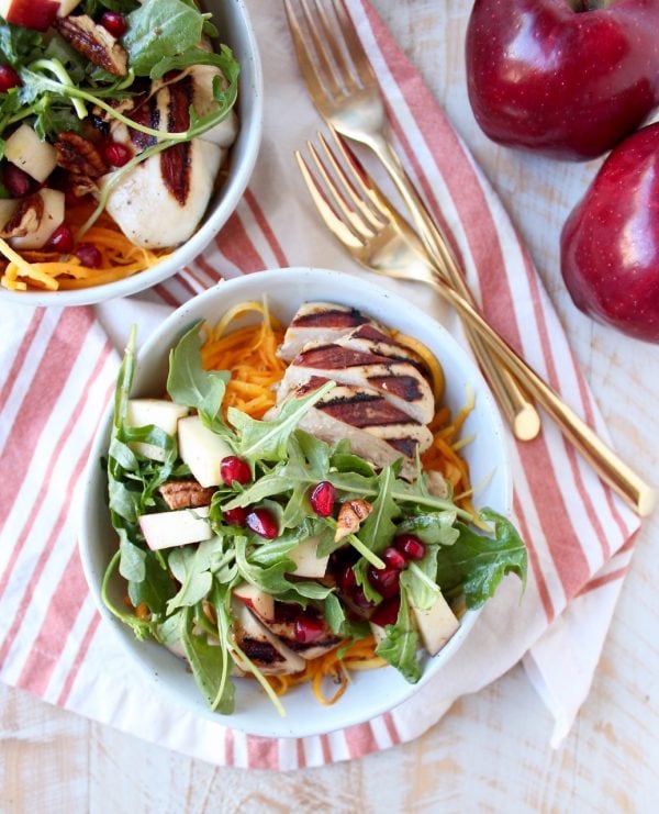 Grilled balsamic chicken & roasted butternut sqaush noodles are topped with a pomegranate apple arugula salad in this healthy, gluten free bowl recipe!