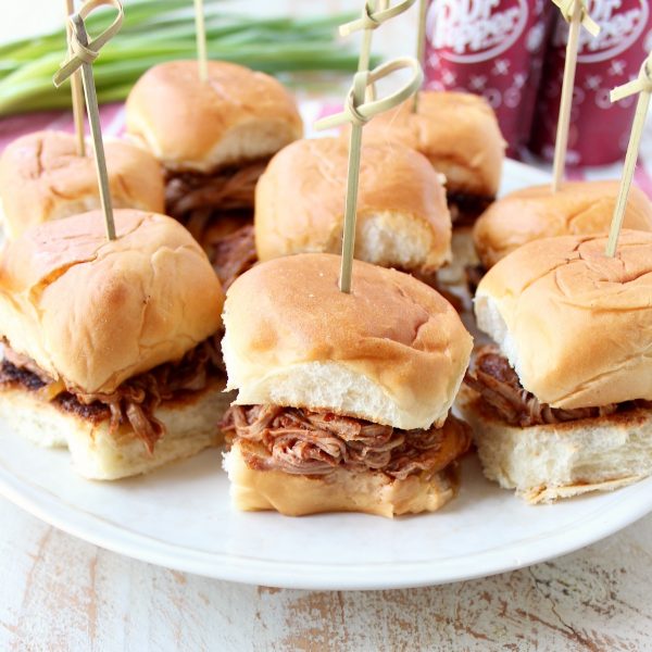 In this scrumptious recipe for Dr Pepper Pulled Pork Sliders, lean pork tenderloin is covered in a delicious spice rub, slow cooked in a Dr Pepper BBQ Sauce, then shredded & served on Hawaiian rolls.