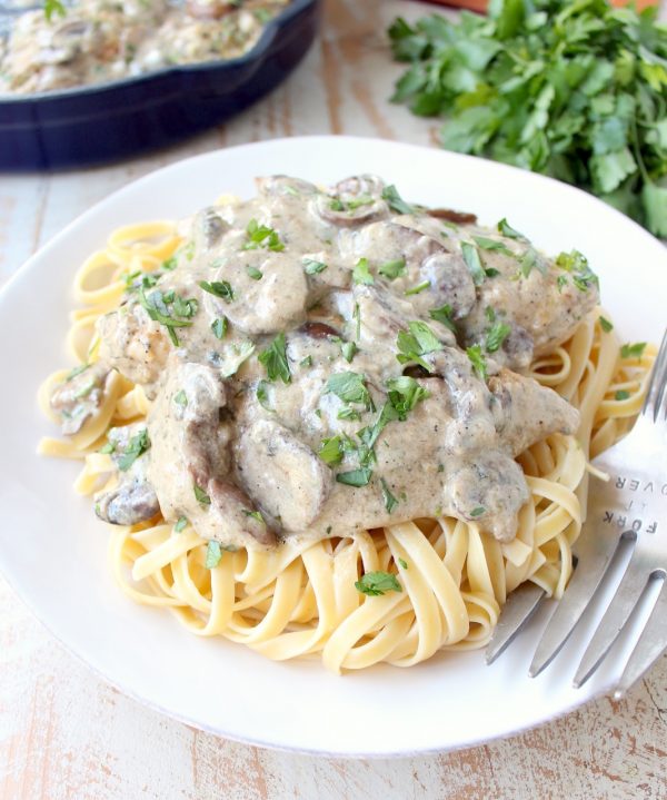 A decadently creamy mushroom sauce covers chicken parmesan in this quick and easy Mushroom Chicken recipe that you'll want to make over and over!