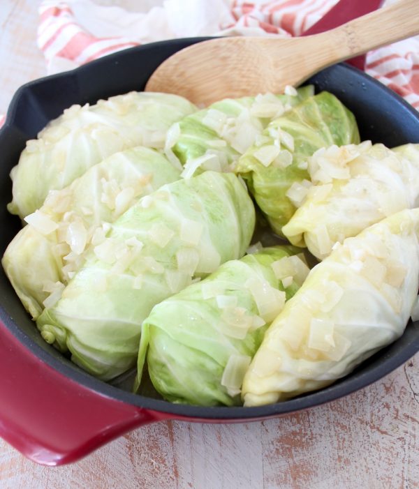 These German inspired Cabbage Rolls are filled with ground pork and sauerkraut, then simmered in a garlic onion broth for an amazingly flavorful recipe! 