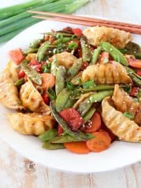 In this scrumptious Chicken Potsticker Stir Fry recipe, fresh veggies, chicken potstickers and a simple stir fry sauce are tossed together in one pan in under 30 minutes for an easy weeknight meal!
