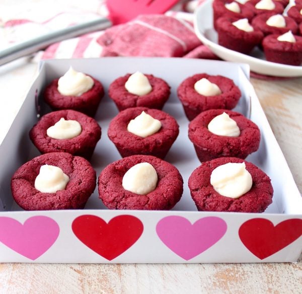 Red velvet cookie cups filled with cream cheese frosting are a delicious and adorable dessert recipe that's also easy to make! Perfect for Valentine's Day, birthdays or any day you're craving a sweet treat!
