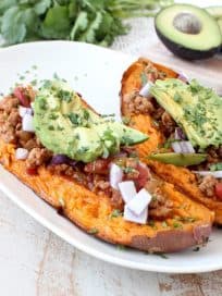 Deliciously easy Whole30 chipotle chili is added to these stuffed sweet potatoes for a scrumptious gluten free and dairy free meal, made in under an hour!