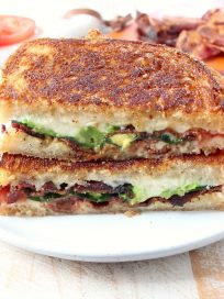 Crispy bacon, creamy avocado and juicy tomatoes are combined in this scrumptious gruyere and avocado grilled cheese sandwich recipe!