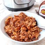 Instant Pot BBQ Chicken is easy to make with chicken breasts, directly from the freezer or refrigerator, plus a bottle of your favorite BBQ sauce. Use it to make different recipes throughout the week, from pasta for dinner, to wraps for lunch!