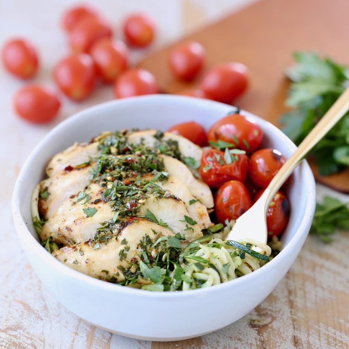 Zucchini Noodles in Gold Fork with Grilled Chimichurri Chicken and Roasted Cherry Tomatoes