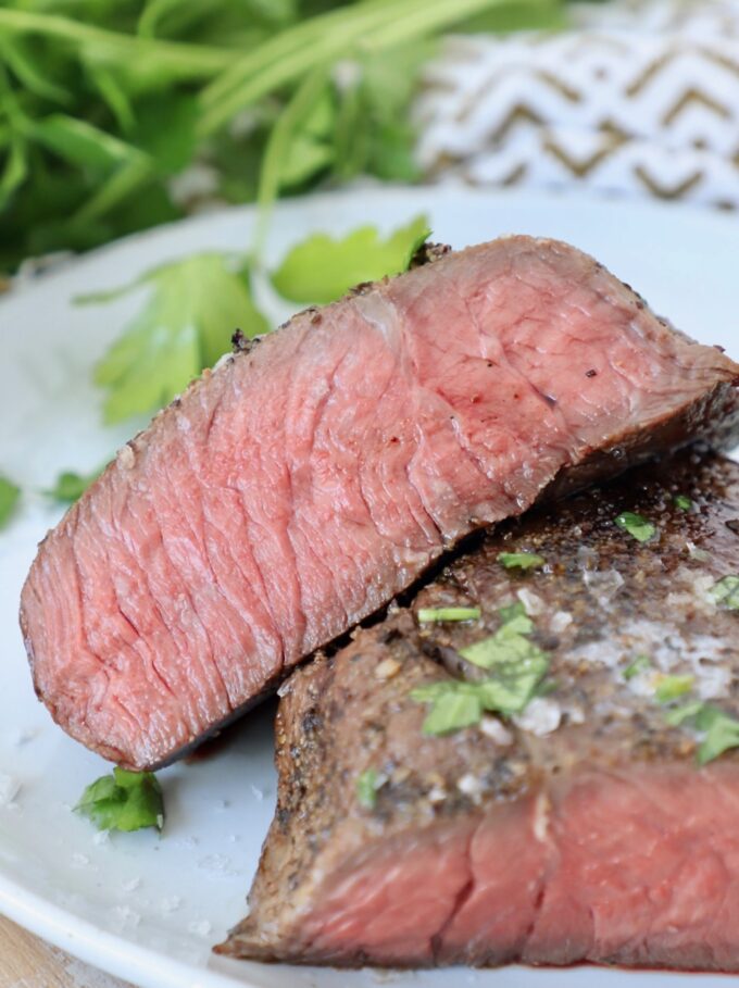 sous vide steak sliced in half on plate