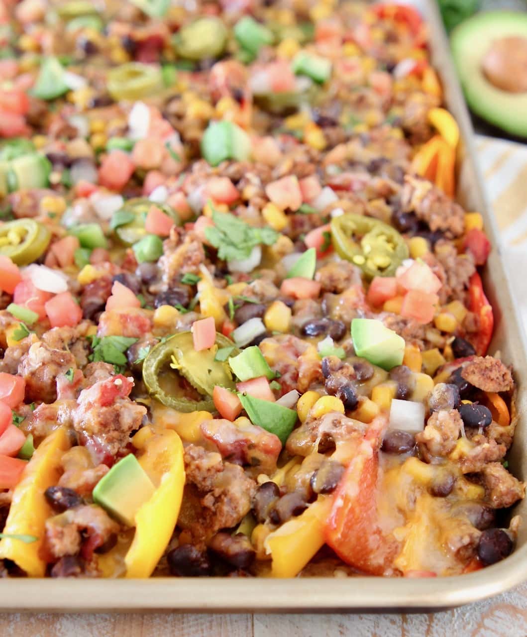Low Carb Nachos made with sweet mini peppers topped with taco seasoned turkey, beans, tomatoes, corn, jalapenos and cheese