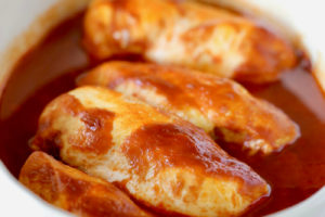 Baked BBQ Chicken in oval casserole dish, image with text overlay "Buffalo BBQ Baked Chicken, Quick & easy weeknight meal"