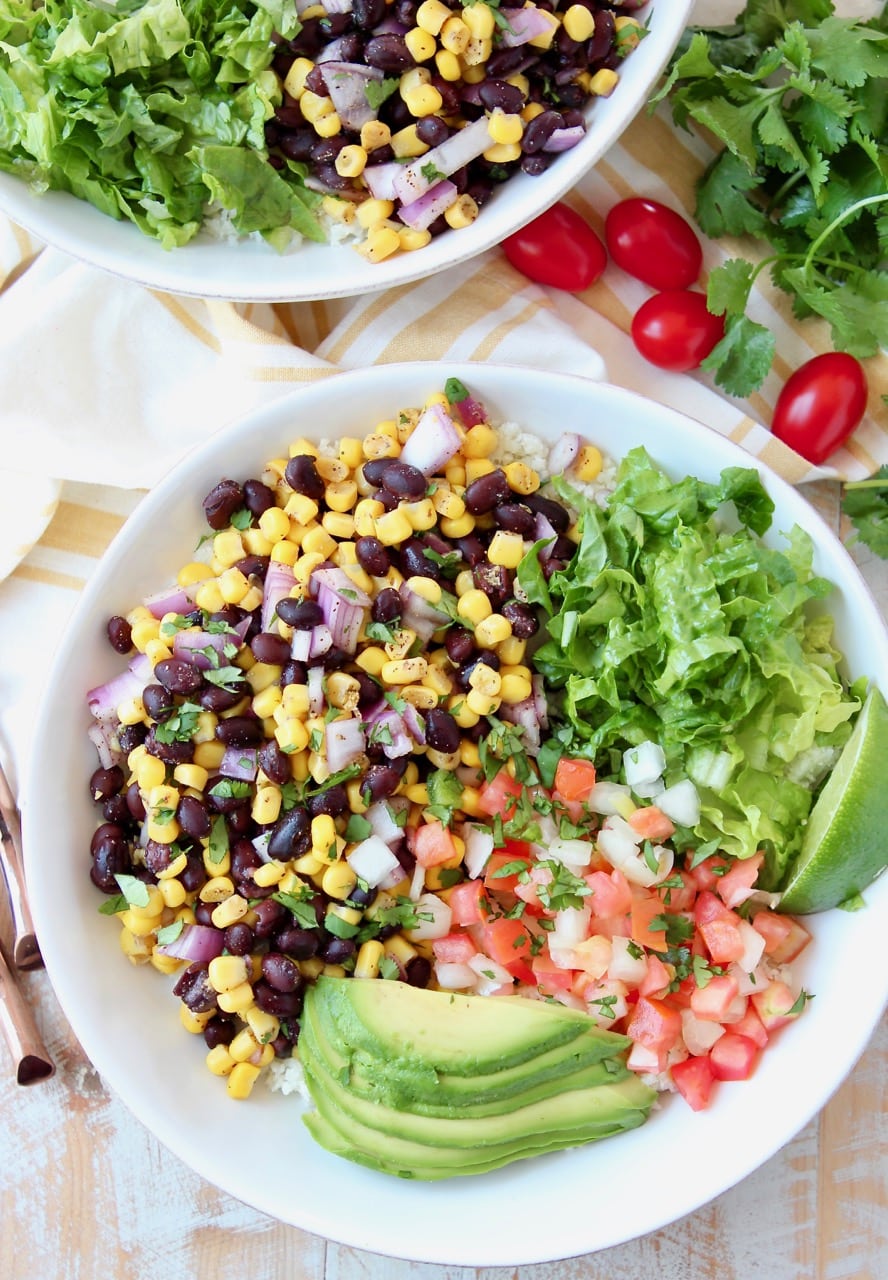 Burrito bowl filled with corn and black bean relish, pico de gallo, avocado and shredded lettuce