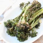 Roasted broccolini on white plate