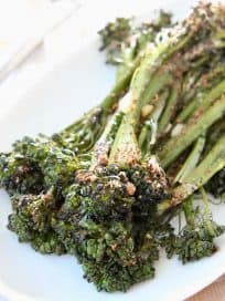 Roasted broccolini on white plate