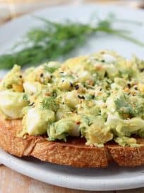 Egg salad on toast topped with everything bagel seasoning and fresh dill