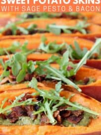sweet potato skins filled with pesto, crumbled bacon and arugula on wood cutting board