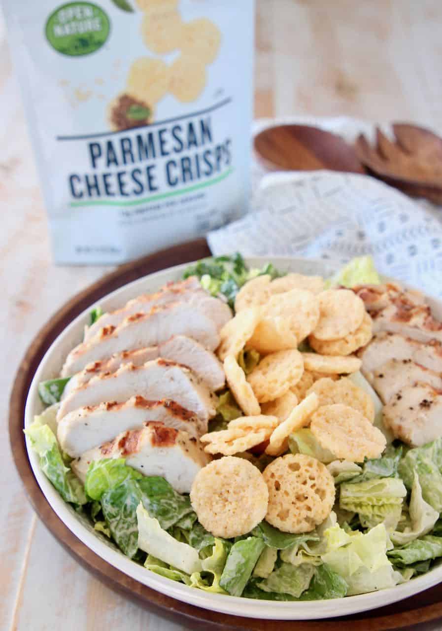 Caesar salad in bowl topped with parmesan cheese crisps