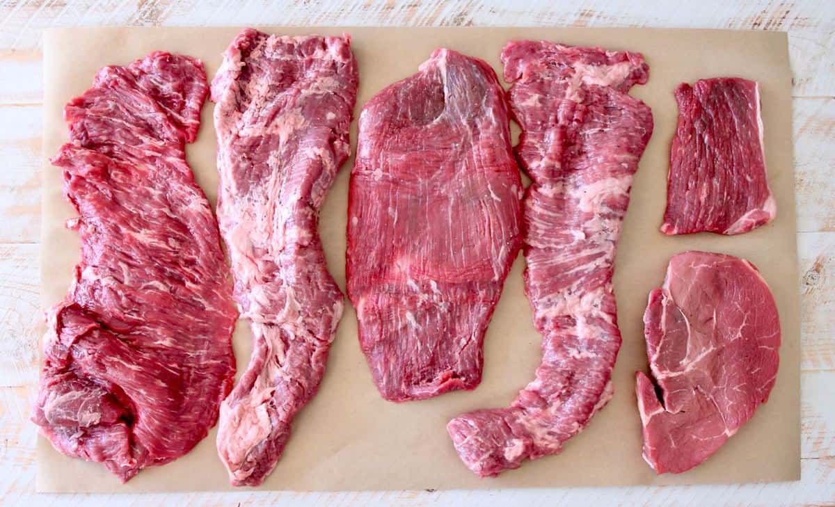 Different cuts of beef for carne asada on butcher paper