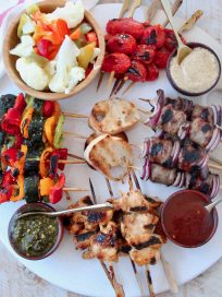 Overhead image of grilled skewers on charcuterie platter