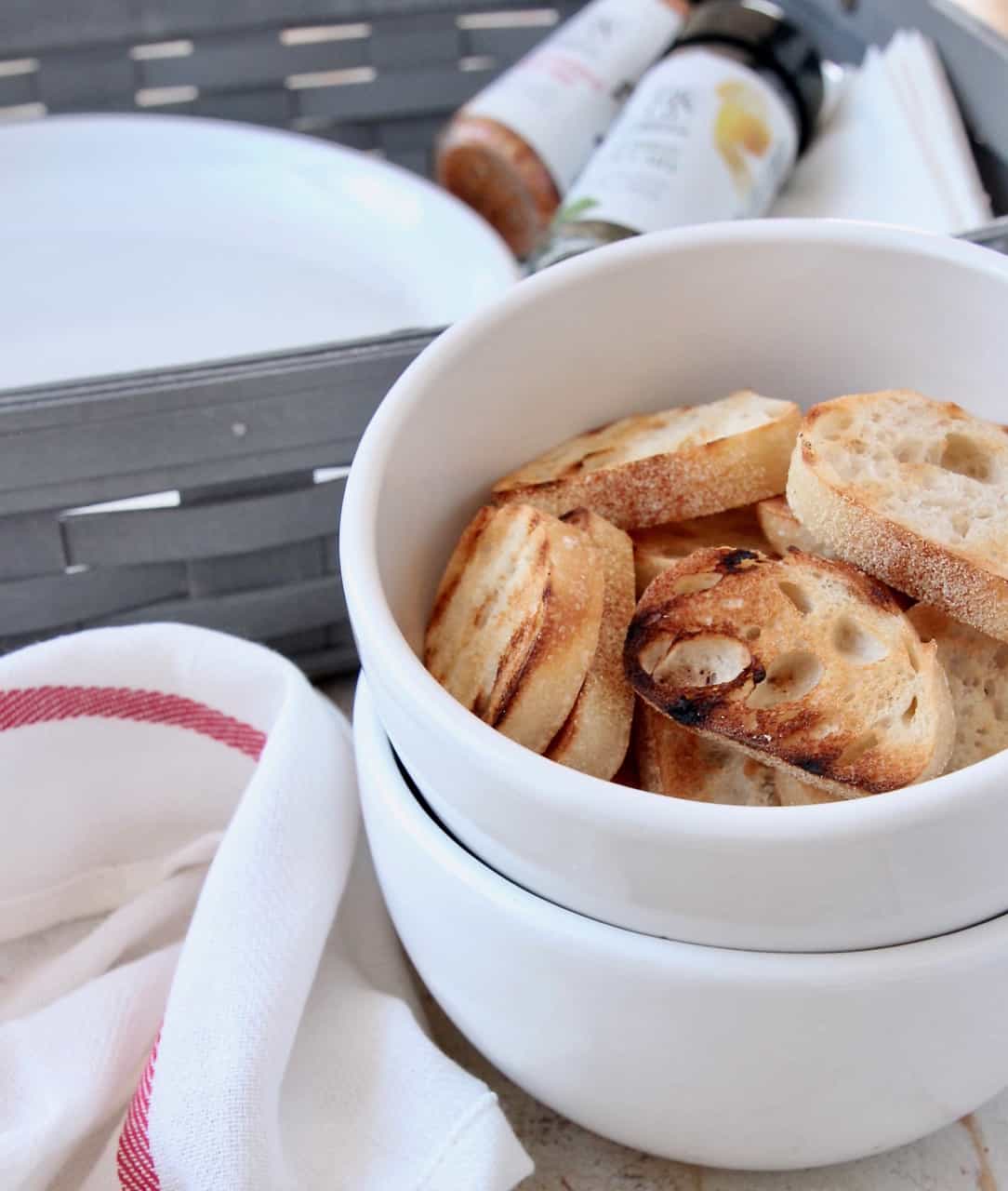 Grilled baguette slices in bowl