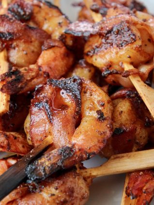 Skewered shrimp wrapped in bacon slices