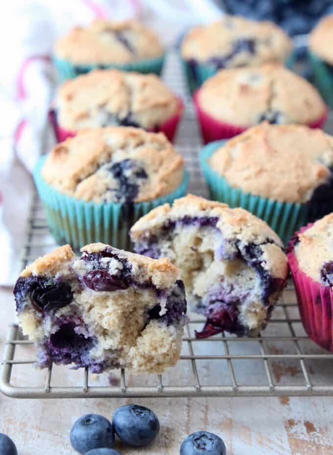 Blueberry muffin cut in half on wire baking rack