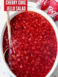 overhead image of cherry coke jello salad in white serving dish with spoon
