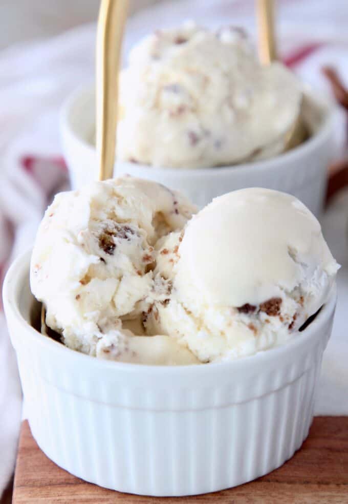 scoops of ice cream in white bowl with gold spoon